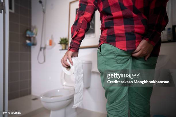 man with diarrhea on the background of the toilet concept photos - hemorrhoid - fotografias e filmes do acervo