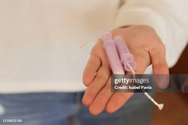 woman holding tampons - tampon stock pictures, royalty-free photos & images