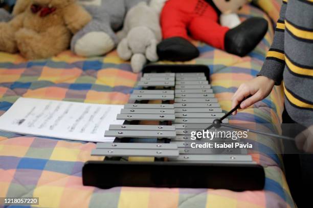boy playing xylophone. homeschooling - marimba fotografías e imágenes de stock