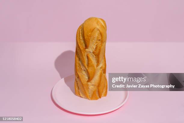 half loaf of bread on a pink plate - migas fotografías e imágenes de stock