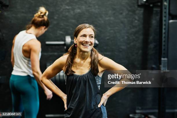 portrait of smiling woman resting during workout in gym - women working out gym stock pictures, royalty-free photos & images