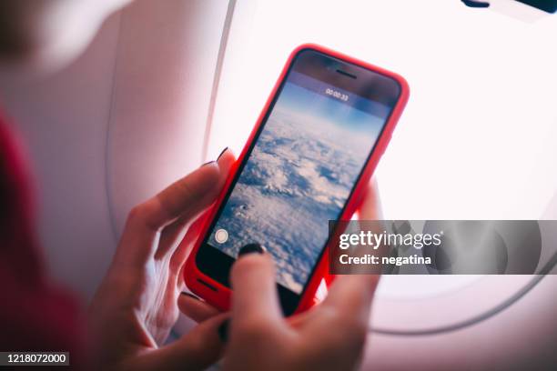 close-up of the hands of young woman recording a video by the smartphone - one woman only videos stock pictures, royalty-free photos & images