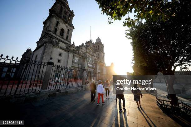 People walk by the closed Mexico City Metropolitan Cathedral on April 10, 2020 in Mexico City, Mexico. Health Emergency was declared by National...