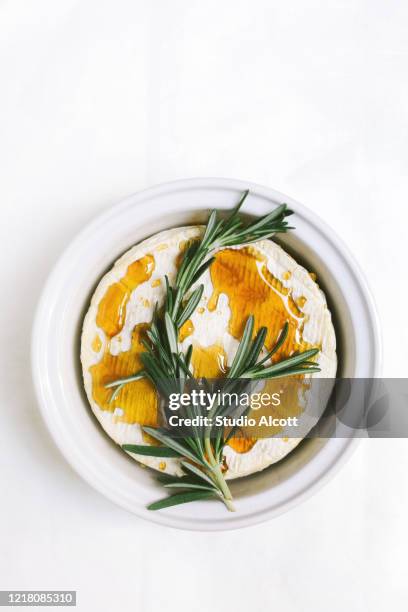 brie with honey and rosemary - brie stock pictures, royalty-free photos & images