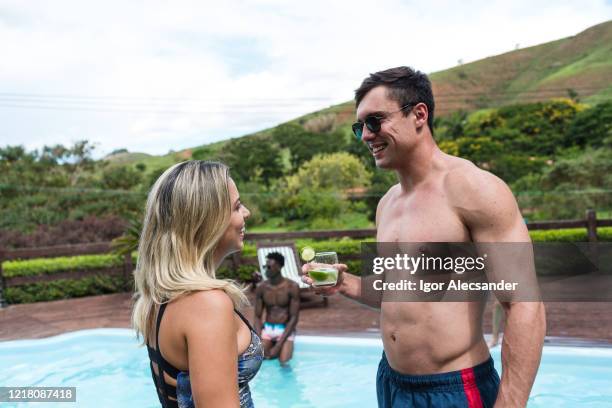 couple in the pool of the summerhouse - caipirinha stock pictures, royalty-free photos & images