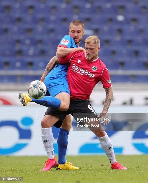 John Guidetti of Hannover 96 is challenged by Patrick Mainka of 1. FC Heidenheim 1846 during the Second Bundesliga match between Hannover 96 and 1....
