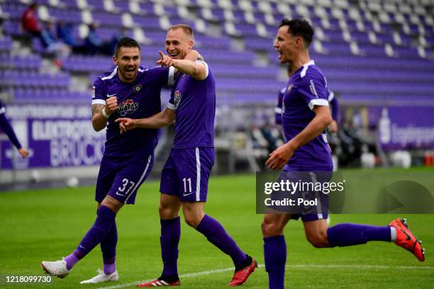 Florian Kruger of Aue celebrates with his team mates after scoring his teams first goal during the Second Bundesliga match between FC Erzgebirge Aue...