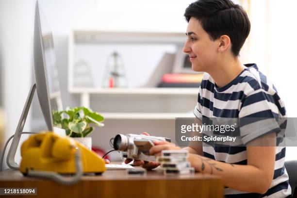 young woman working from home at her video editing job - north america editor stock pictures, royalty-free photos & images