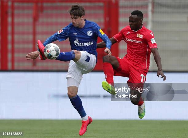 Schalke's Juan Miranda, left, fights for the ball with Union's Anthony Ujah during the Bundesliga match between 1. FC Union Berlin and FC Schalke 04...