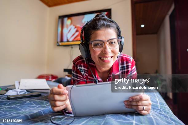 woman in her bed working from home for covid-19 emergency - latin script stock pictures, royalty-free photos & images