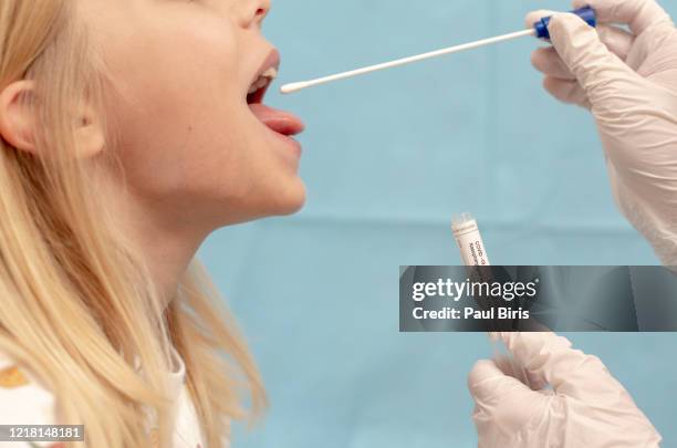 close up of doctor taking sample from mouth, novel coronavirus (2019-ncov), coronavirus, covid-19 - coronavirus romania stock pictures, royalty-free photos & images