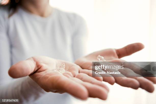 young woman applying antibacterial sanitize gel on both hands - gel stock pictures, royalty-free photos & images