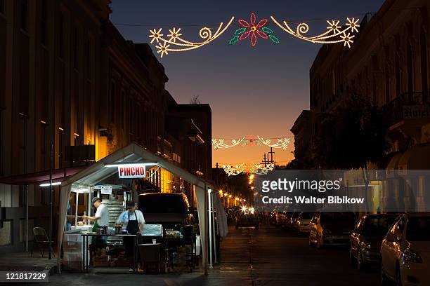 fiesta pincho or hot dog stand at dusk, plaza las delicias, ponce, puerto rico, december 2009 - hot puerto rican women stock pictures, royalty-free photos & images