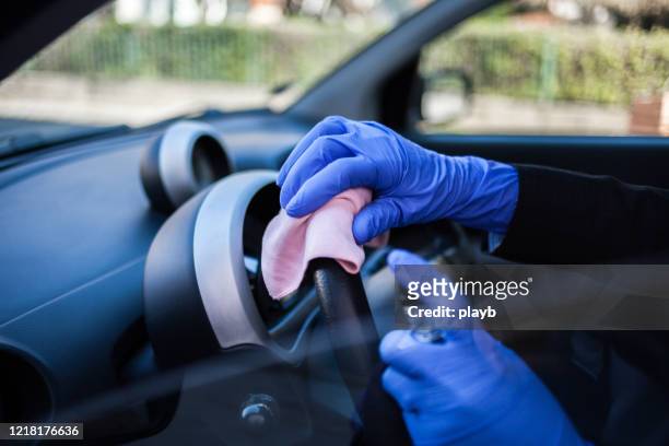 woman wiping down steering wheel - cleaning inside of car stock pictures, royalty-free photos & images