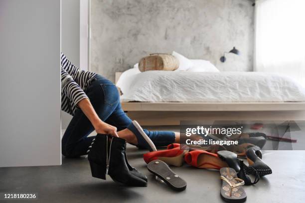 woman cleaning shoes closet - choosing shoes stock pictures, royalty-free photos & images