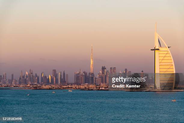 dubai skyline in the evening - jumeirah beach stock pictures, royalty-free photos & images