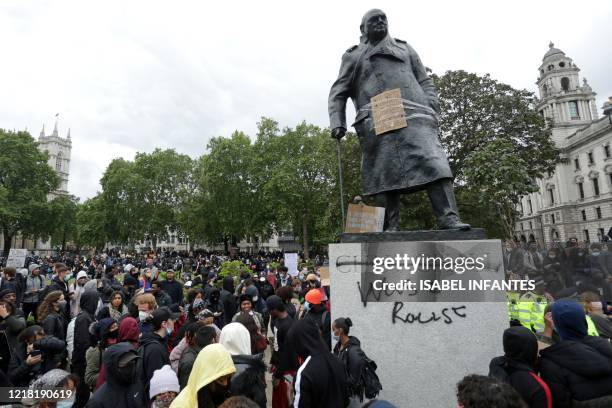 The statue of former British prime minister Winston Churchill is seen defaced, with the words "was a racist" written on it's base in Parliament...