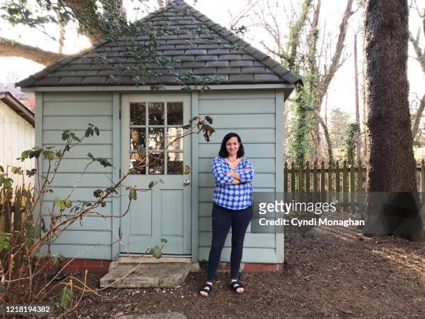 happy, confident female artist standing outside her art studio - shed stock pictures, royalty-free photos & images