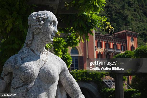 statue and queen's pavillion building, grand hotel villa d'este, cernobbio, lake como, lakes region, milan, lombardy, italy - expensive statue stock-fotos und bilder