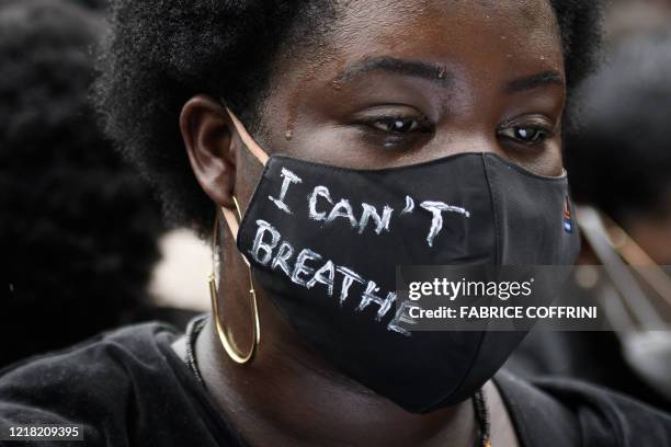Woman wearing a protective face mask reading "I can't breathe" during a protest against racism and police brutality in Lausanne on June 7, 2020 in...