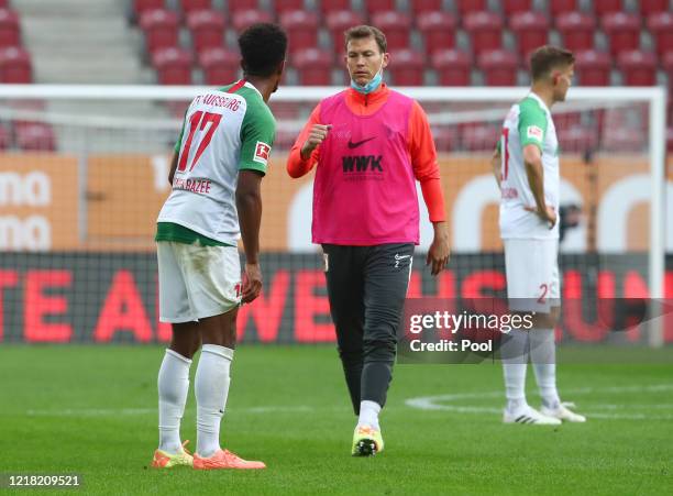 Stephan Lichtsteiner and Noah Sarenren Bazee of FC Augsburg fist bump after the Bundesliga match between FC Augsburg and 1. FC Koeln at WWK-Arena on...