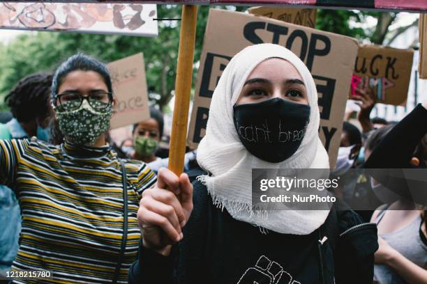 A Muslim woman with face mask I can not breath takes part in Black Lives Matter protest in Cologne, Germany, on June 7, 2020