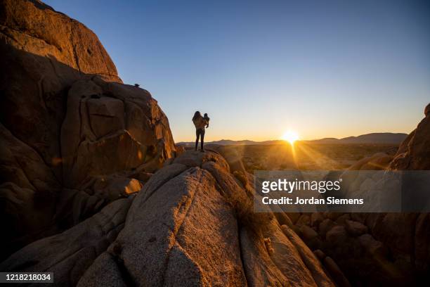 a woman and her son taking in sunset in the desert. - palm springs california photos et images de collection