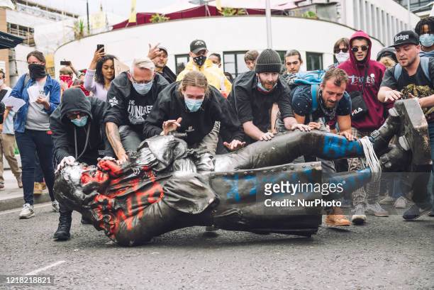 Protesters transporting the statue of Colston towards the river Avon. Edward Colston was a slave trader of the late 17th century who played a major...