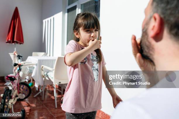 father teaches his daughter to whistle - whistle stock pictures, royalty-free photos & images