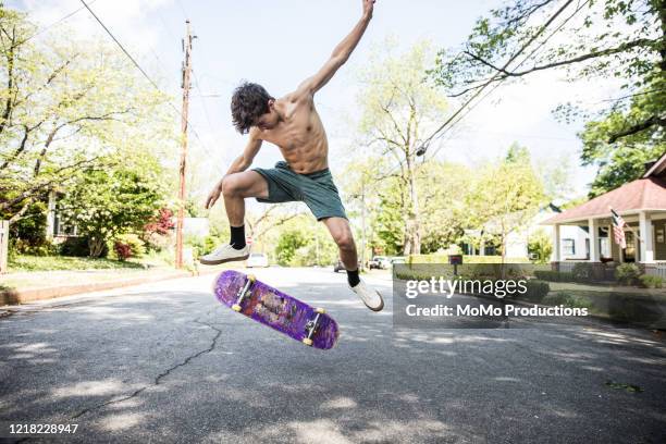 teenage boy skateboarding on suburban street - skinny teen ストックフォトと画像