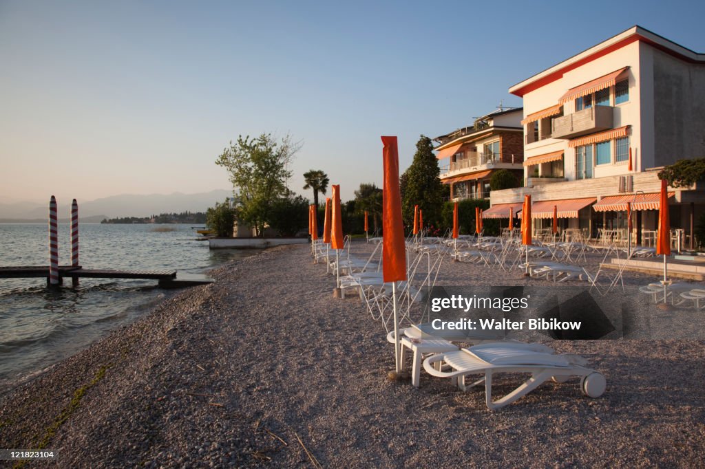 Lakeside beach at sunset, Sirmione, Lake Garda, Lake District, Lombardy, Italy