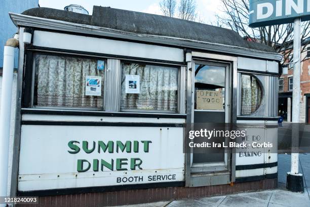 The Historic Summit Diner opened in 1929 with a handwritten sign in the window stating, "Open To Go." Photographed in Summit, NJ, USA on April 10,...