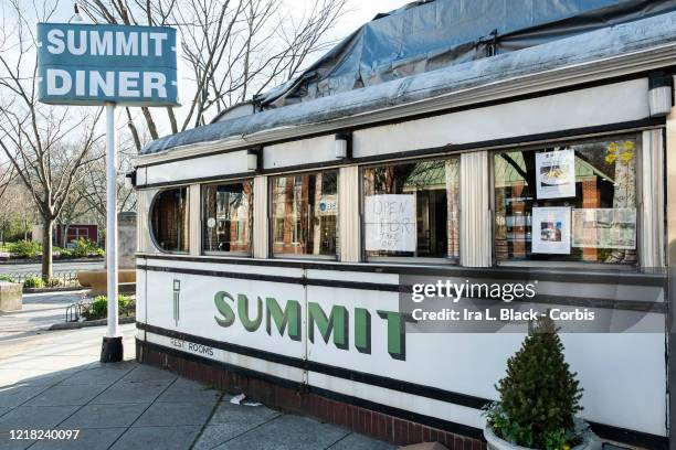 The Historic Summit Diner opened in 1929 with a handwritten sign in the window stating, "Open for Take Out." Photographed in Summit, NJ, USA on April...