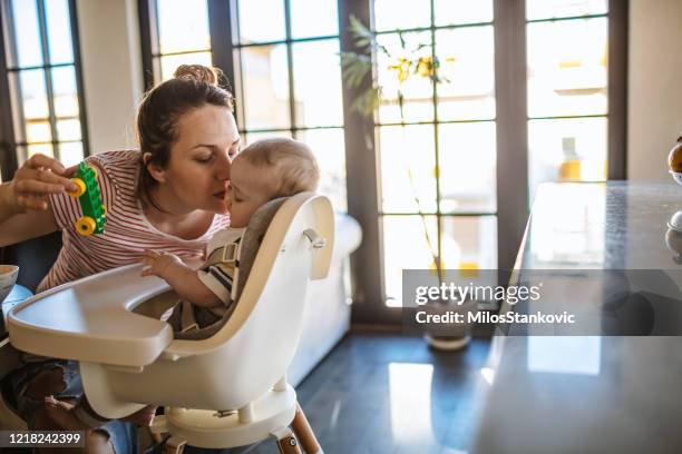 playfull mum with little baby boy - high chair isolated stock pictures, royalty-free photos & images
