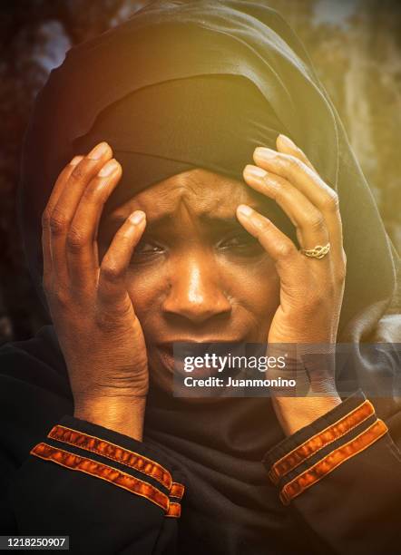 terrified black refugee muslim young woman because the horrors of pandemic - mali stock pictures, royalty-free photos & images