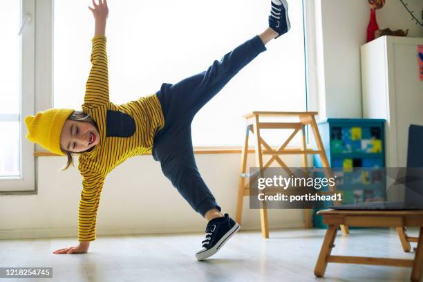 little boy dancing break at home. home pleasures. - boy handstand stock pictures, royalty-free photos & images