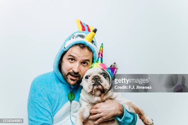 man in chicken costume next to dog with unicorn headband - animal themes stock pictures, royalty-free photos & images