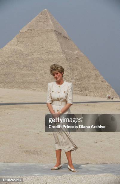 Diana, Princess of Wales visits the pyramids on the Giza Plateau in Egypt, 12th May 1992. She is wearing a cream suit by Catherine Walker.