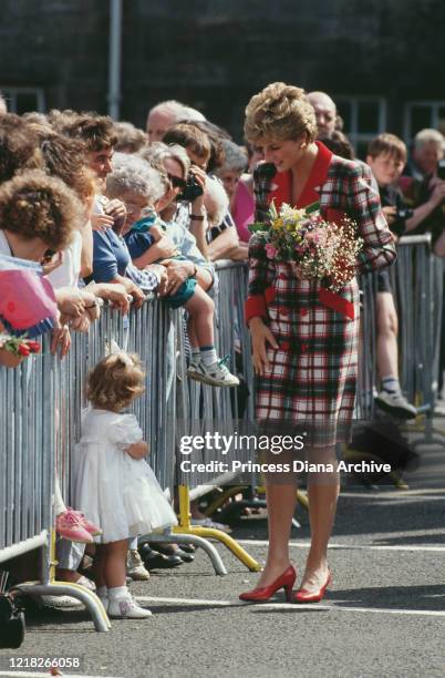 Diana, Princess of Wales visits Paisley in Scotland, 19th June 1992. She is wearing a tartan coat-dress by Catherine Walker.
