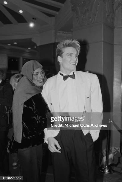 Swedish actor Dolph Lundgren and his partner, Jamaican singer Grace Jones at the premiere of the film 'Rocky IV' at the Westwood Village Theatre in...