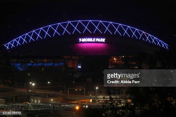 General view of T-Mobile Park lit up in blue to honor essential workers during the coronavirus outbreak on April 09, 2020 in Seattle, Washington.