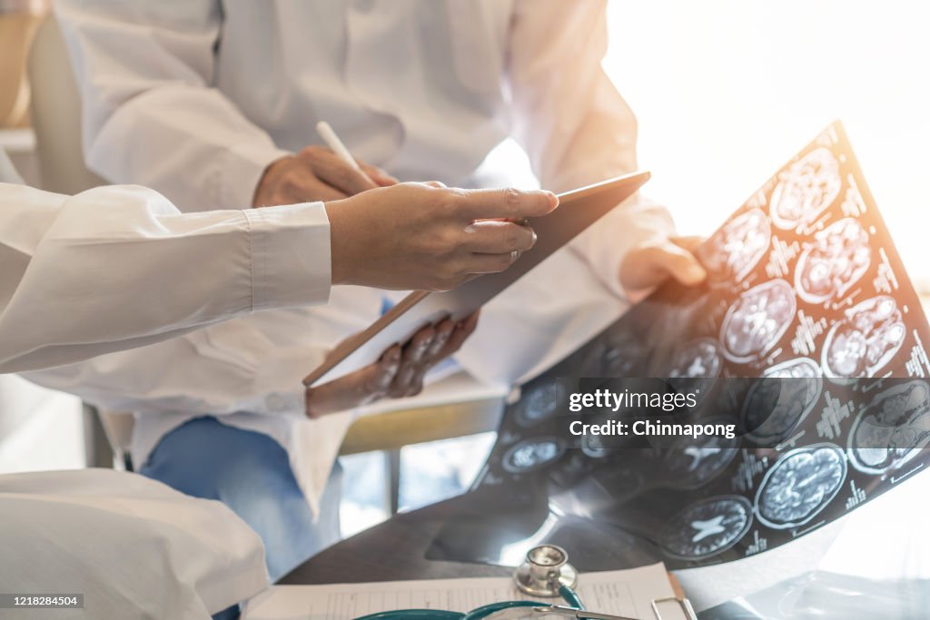 ER surgery medical team, surgical doctor teamwork, professional brain and neurological surgeon with digital tablet working in hospital clinic discussion, diagnosing on patient care operation service