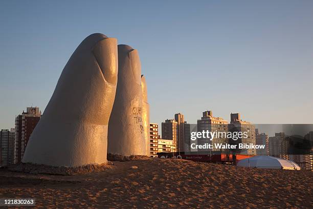 hand in the sand sculpture, la mano en la arena, playa brava beach, punta del este, uruguay, february 2009 - uruguay stock pictures, royalty-free photos & images