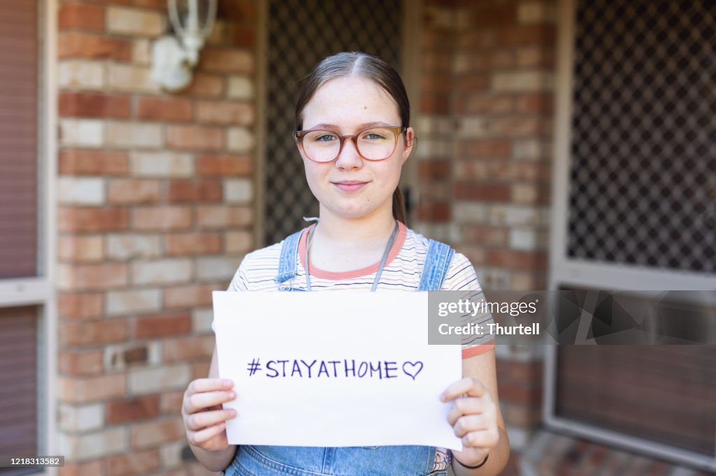 Girl Holding Stay At Home Sign