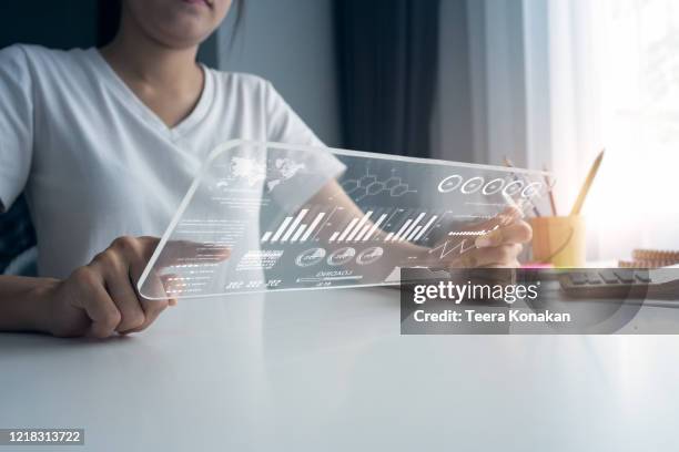 businesswoman using laptop sitting at desk in home office - virtual author stock pictures, royalty-free photos & images