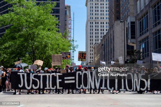 Demonstrators march from Fountain Square to the Hamilton County Courthouse during todays protest. An estimated 5,000 or more people gathered downtown...