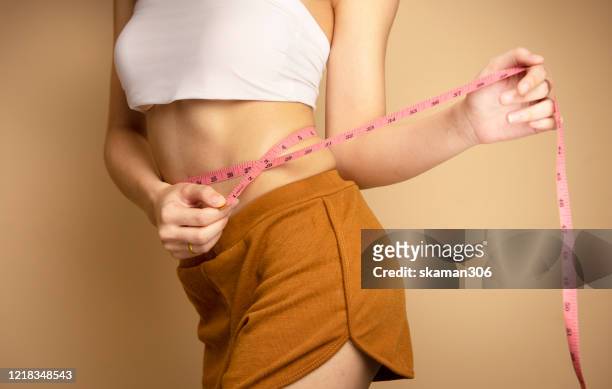 beautiful asian female and slim body with measures waist  and workout weight loss goals - slim stock pictures, royalty-free photos & images