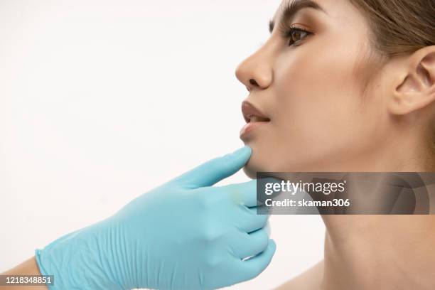 beautiful asian female good skin and surgical gloves use syringe beauty clinic use botox and facial treatment surgery concept - human mouth stock photos et images de collection