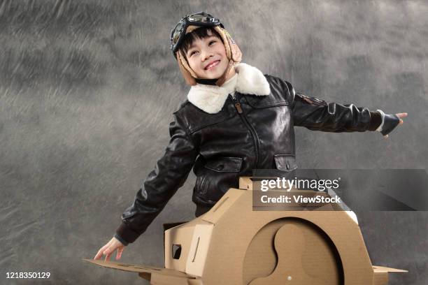 happy children's driving paper airplanes - pilot jacket stock pictures, royalty-free photos & images