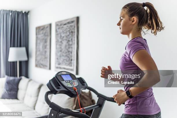 home gym for brunette teenage girl on a treadmill - treadmill stock pictures, royalty-free photos & images